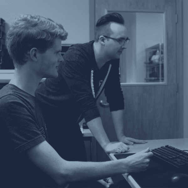 Background image of two SteppIR employees doing work on a computer